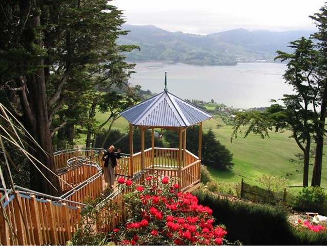 Larnach Castle grounds with a view from the ridge of Otago Peninsula of the water